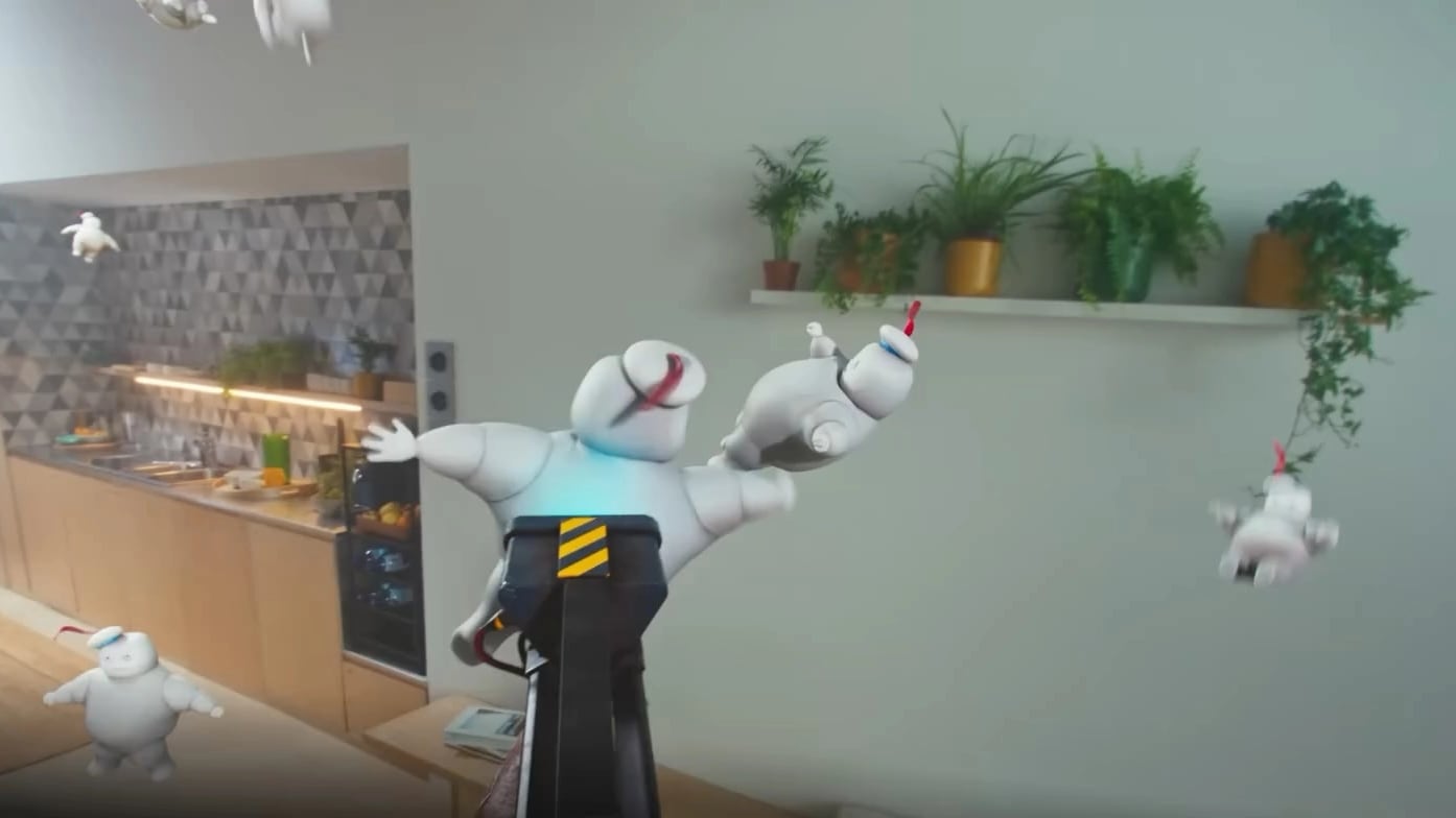 Mixed reality on a Meta Quest 3: cartoon marshmallow ghosts flying around a real kitchen and living room as the player aims a proton blaster