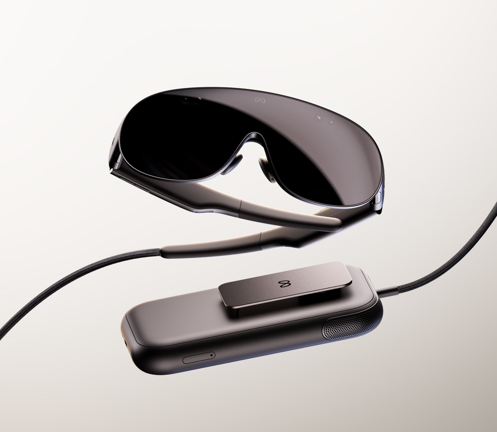 Meta VR Glasses, a dark wraparound visor with temple arms, connected by a braided cable to a clip-on compute puck